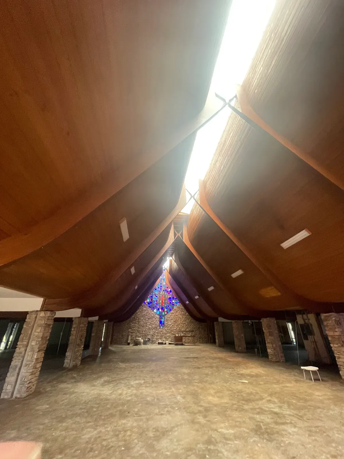 Church sanctuary with a sandblasted wood ceiling and stained glass