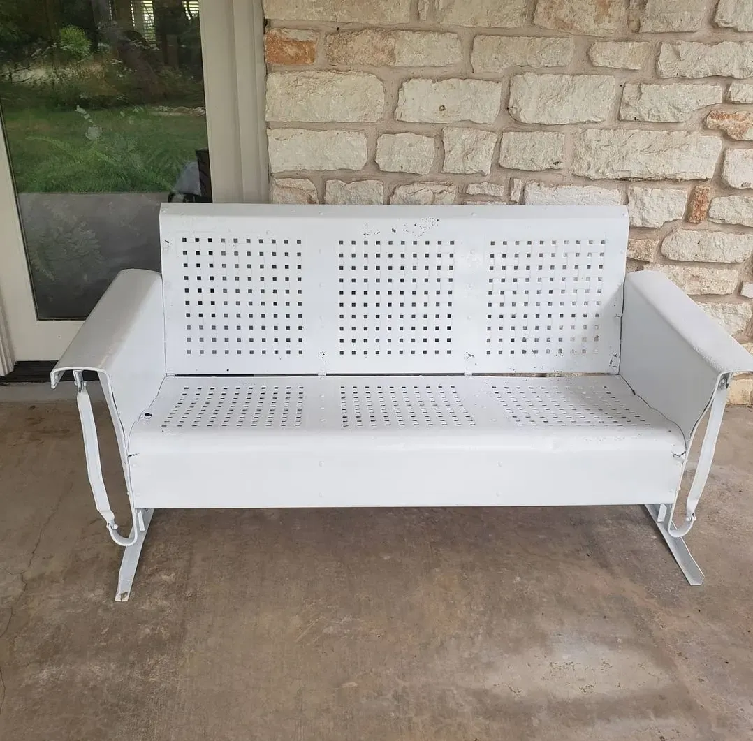 Vintage metal glider bench refinished white after sandblasting