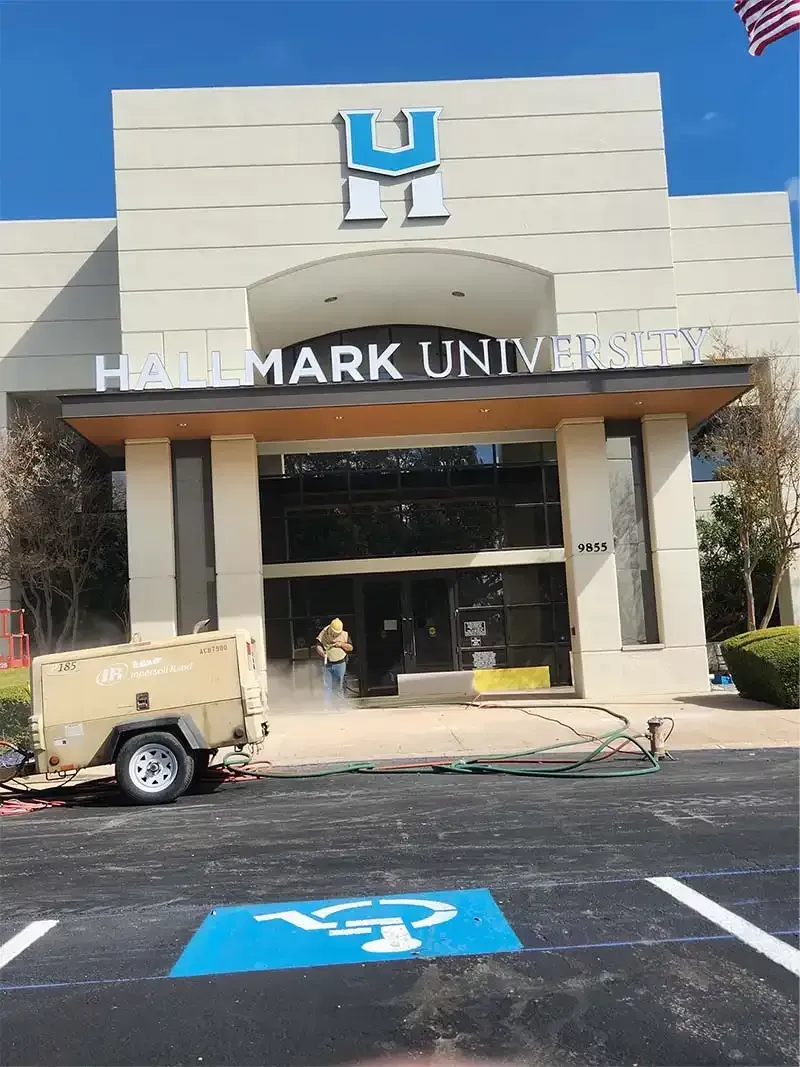 Sandblasting compressor parked outside a university entrance