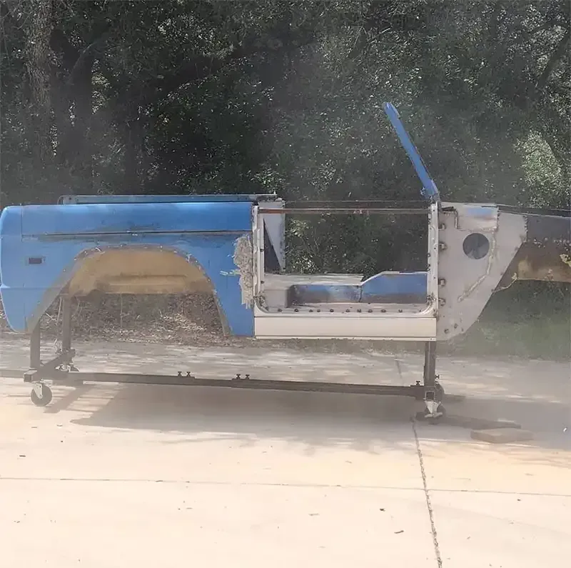 Blue classic truck body partially blasted to bare metal