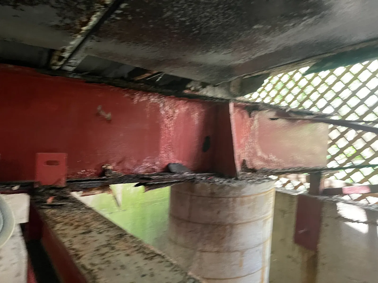 Rusted red steel beam underside before blast cleaning