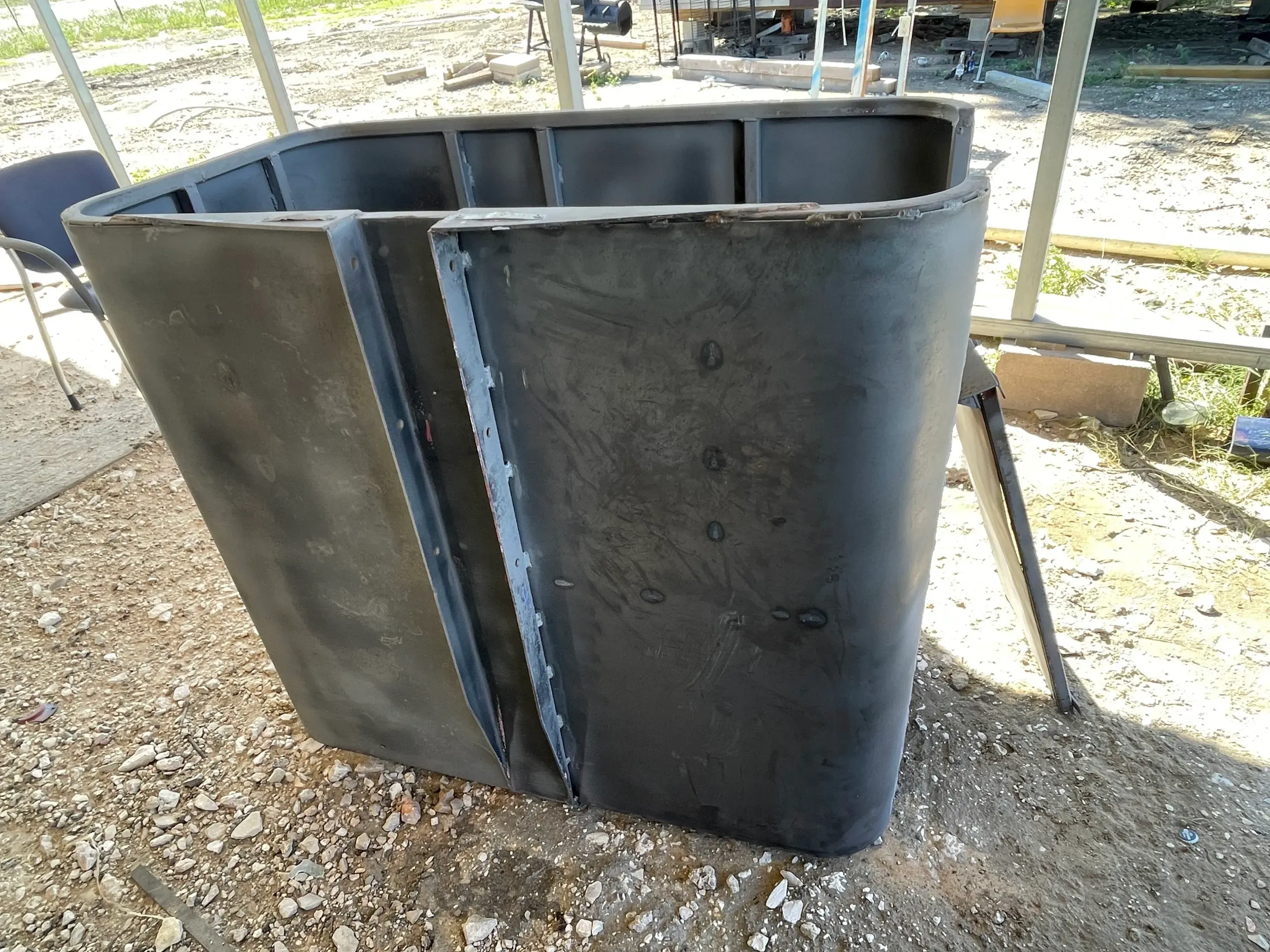 Steel tank shell partially sandblasted to bare metal