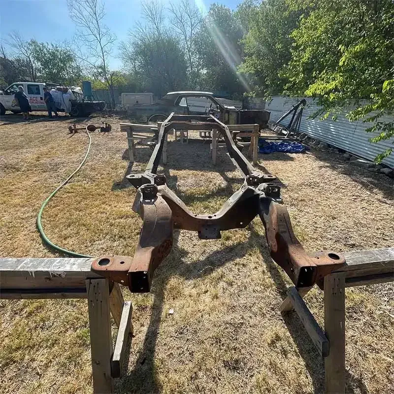 Rusted vehicle frame on stands after sandblasting