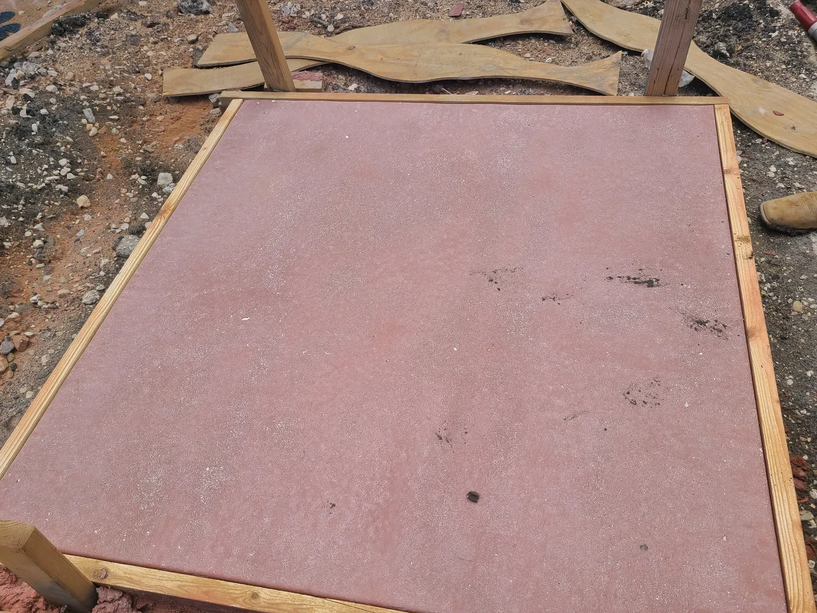 Small concrete slab with a sandblasted finish inside wood forms