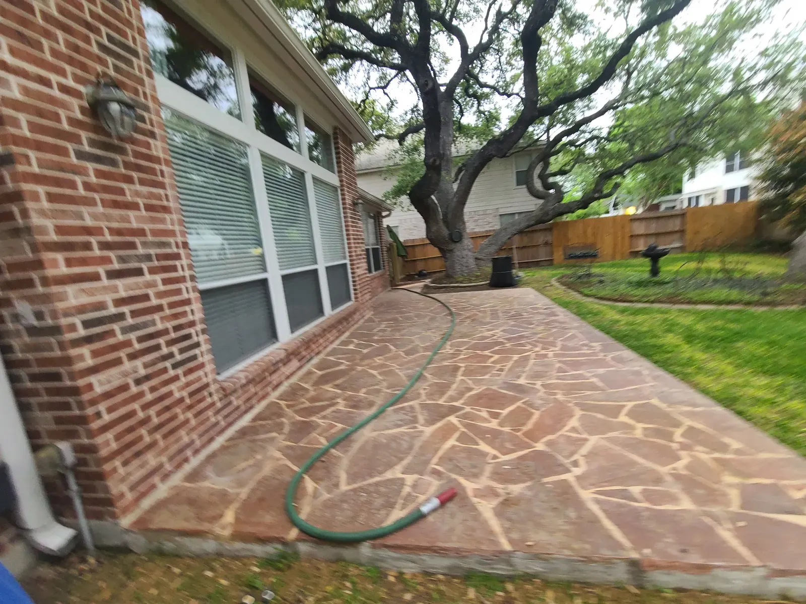 Red flagstone patio along a brick home after sandblasting