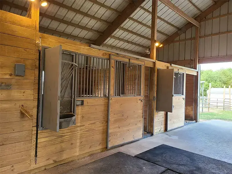 Row of restored wooden horse stalls after sandblasting
