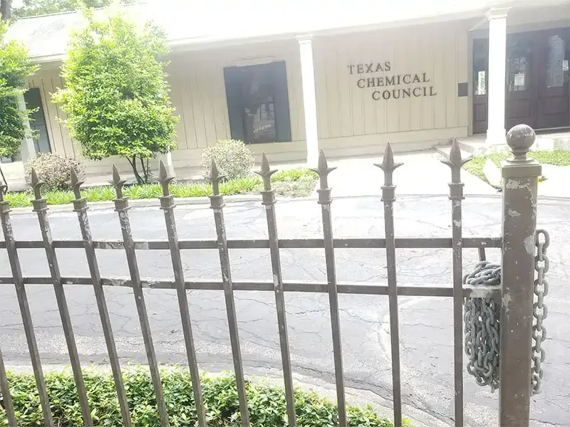 Wrought iron fence at the Texas Chemical Council office before blasting