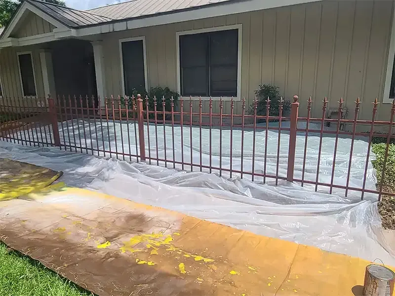 Iron fence freshly primed after sandblasting at a home