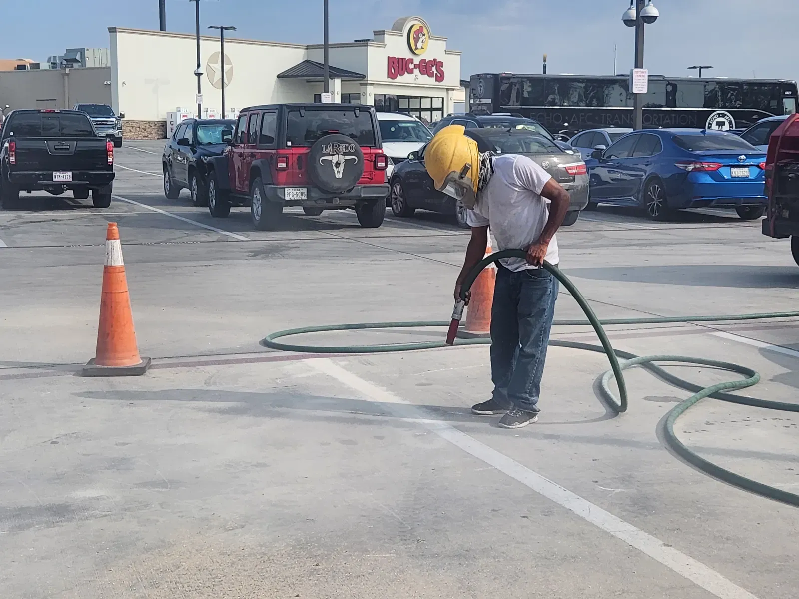 Technician blasting striping in a crowded Buc-ee’s parking lot