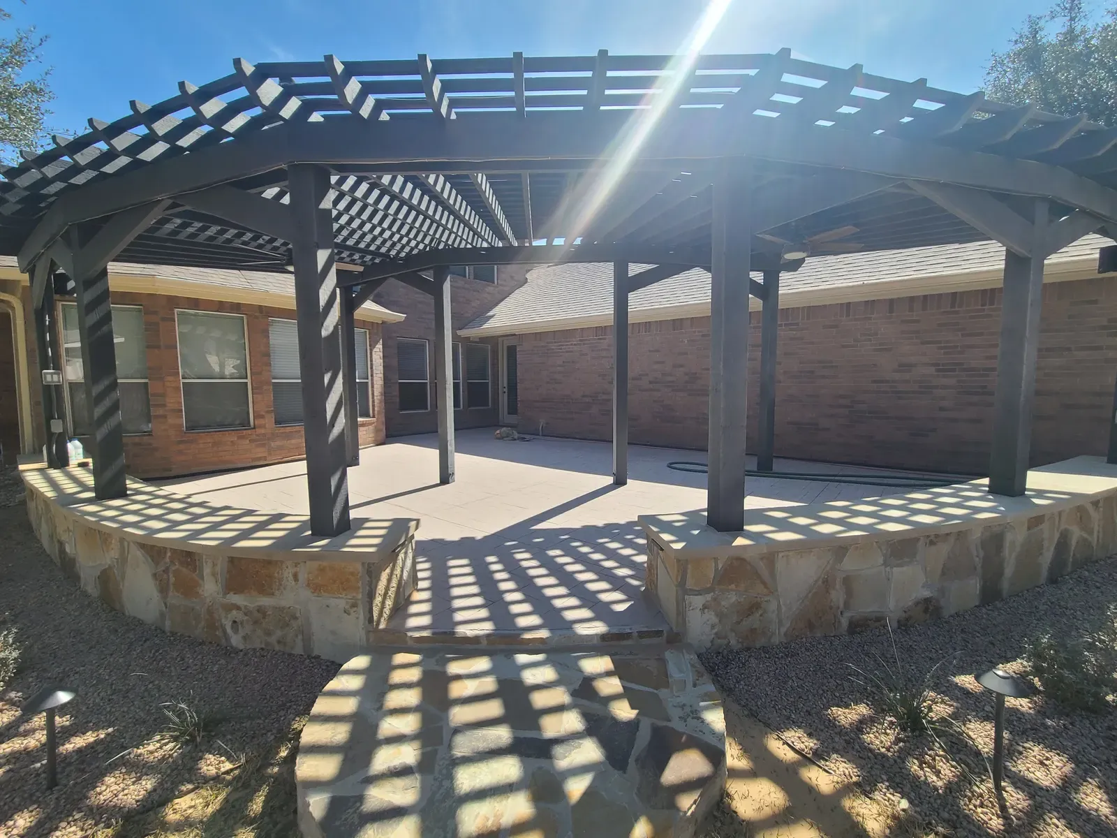 Shaded pergola and stone patio after residential sandblasting