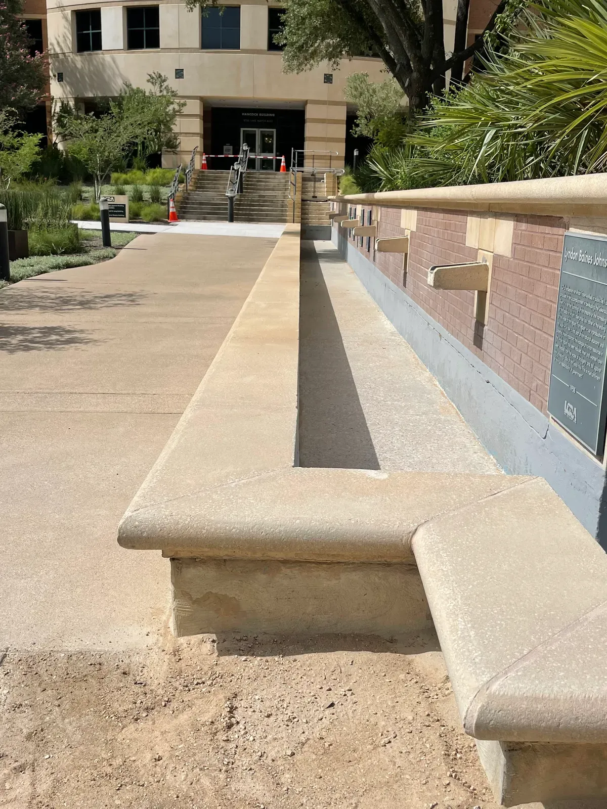 Concrete planter ledge along a walkway after sandblasting