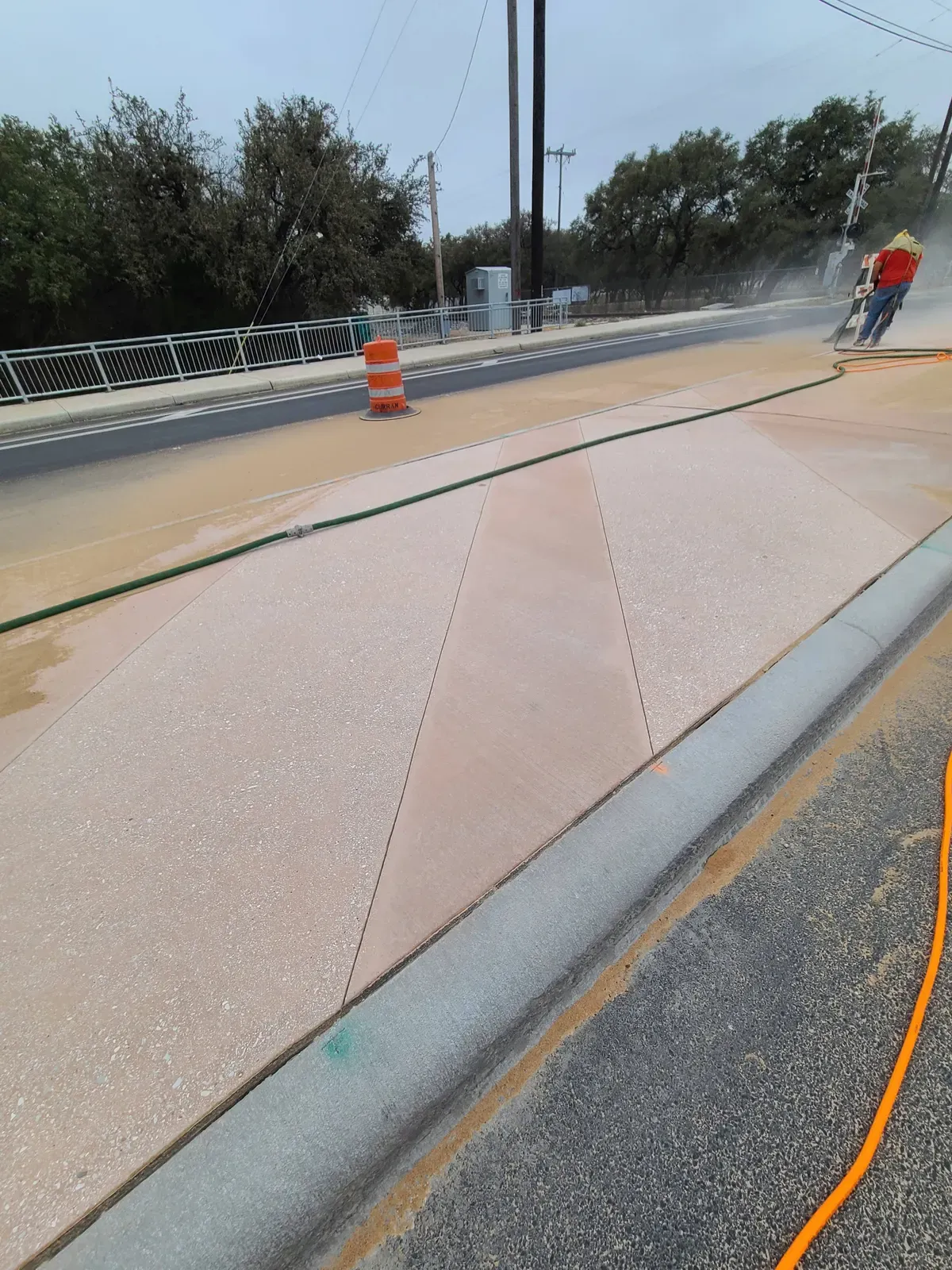 Roadside concrete sidewalk freshly sandblasted beside a highway