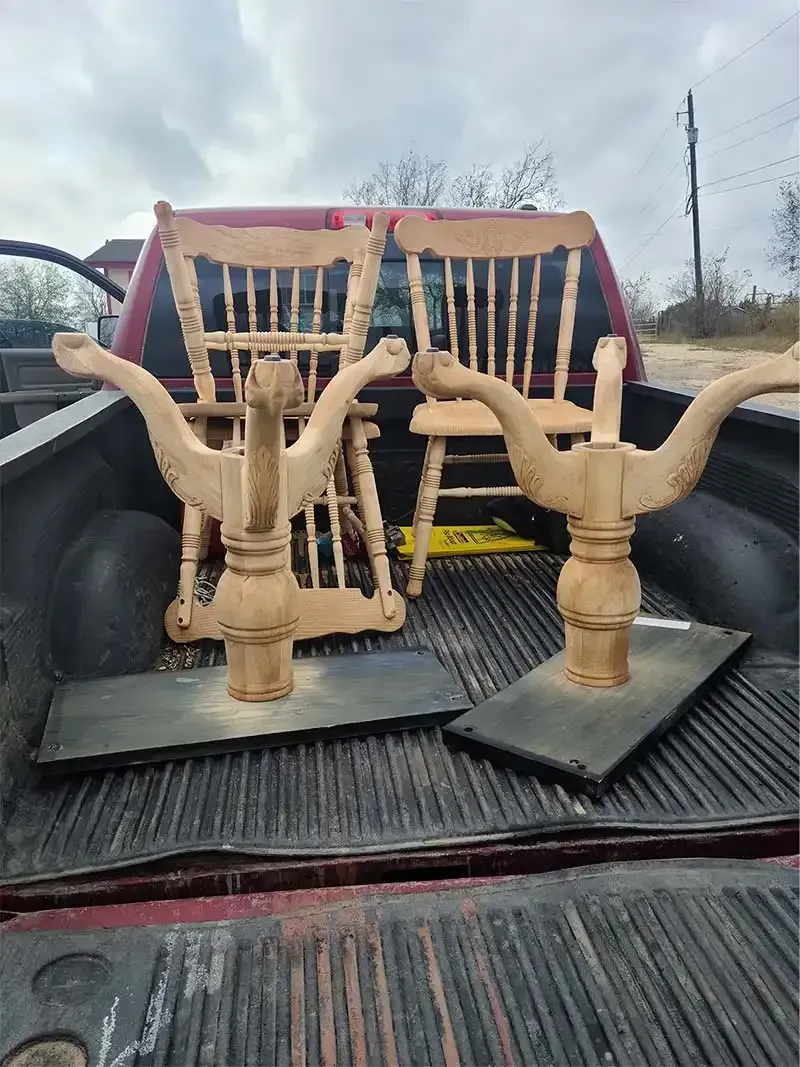 Sandblasted wooden rocking chairs in a pickup truck bed
